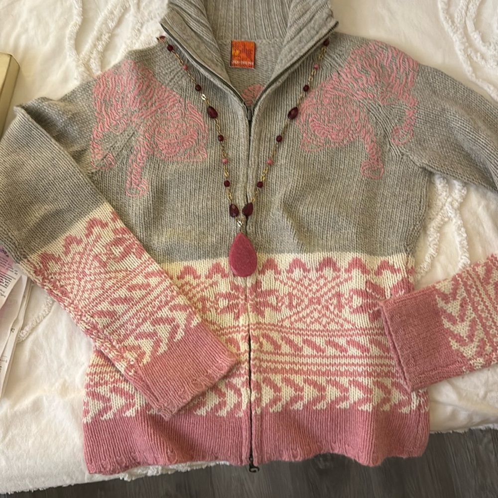 Warm, cozy knit winter motif double zipper sweater.